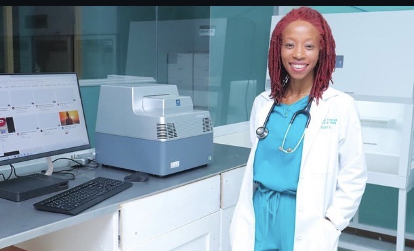 Dr. Mellesia Lee in the MELL laboratory beside molecular testing equipment